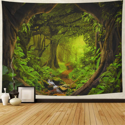 Large wall tapestry featuring a vibrant green forest with a cascading waterfall over rocks, displayed in a room.