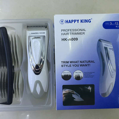 White and silver electric hair clipper held in hand, with a grey guide comb and blue packaging on a woven surface. - Image 6