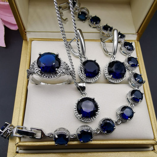 Four-piece silver-tone jewelry set with round green gemstones, including a necklace, bracelet, ring, and dangle earrings. - Image 16
