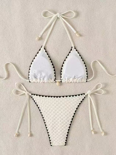 Black textured bikini with white scalloped trim, halter top, and tie-side bottoms featuring small shell details. - Image 12