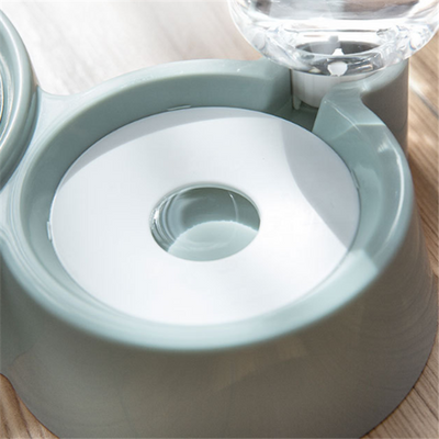 White pet feeding station with a stainless steel food bowl and a clear automatic water dispenser bottle. - Image 3