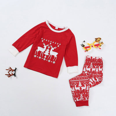 Red long-sleeve Christmas pajama set with white reindeer and Christmas tree patterns, featuring a crew neck top and patterned pants. - Image 4