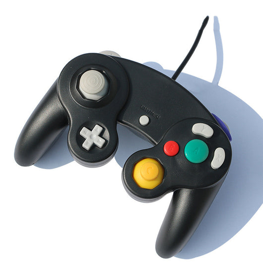 Orange wired gamepad with a USB connector, featuring a D-pad, joystick, and colored action buttons.