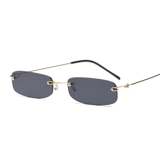 Rimless trendy sunglasses with rectangular orange lenses and gold-tone metal frames, featuring black temple tips.