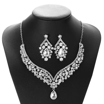 Sparkling silver-tone necklace and matching earrings set with clear round and teardrop rhinestones on a black display. - Image 4