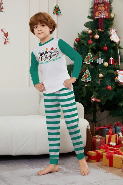 Family of four wearing matching green and white striped Christmas pajamas with "Merry Christmas" graphic. - Image 20