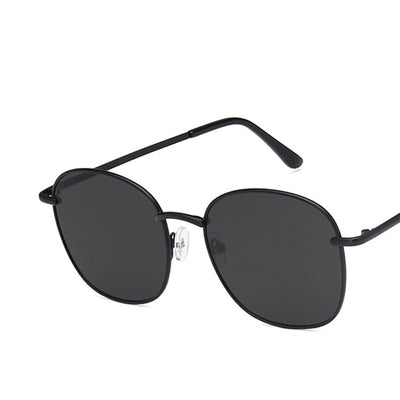 Gold metal round sunglasses with dark gray resin lenses and black temple tips on a white background. - Image 10