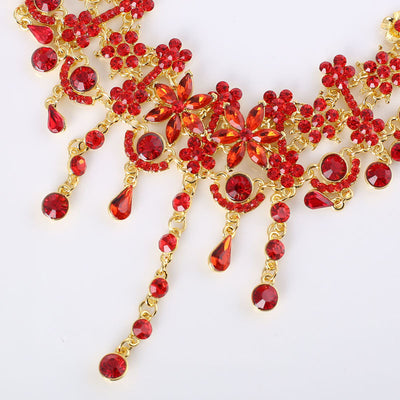 Red and gold bridal jewelry set with a statement necklace and matching dangle earrings, featuring floral and teardrop rhinestones. - Image 4