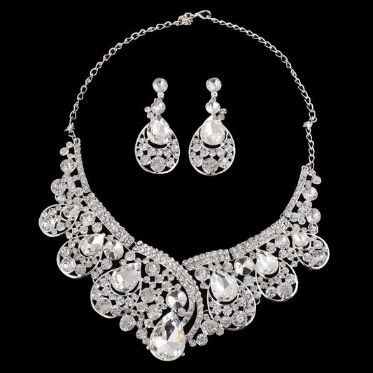 Silver-tone necklace and matching drop earrings set with clear rhinestones and teardrop crystals, ideal for weddings.