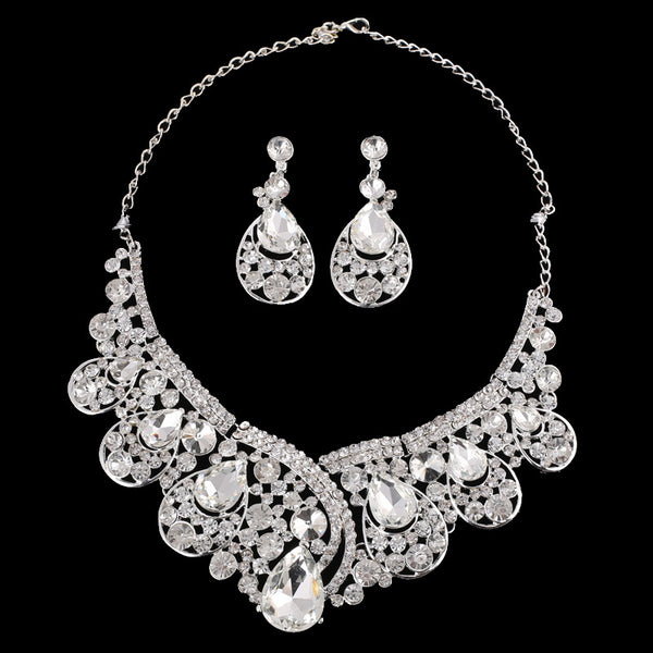 Silver-tone necklace and matching drop earrings set with clear rhinestones and teardrop crystals, ideal for weddings.