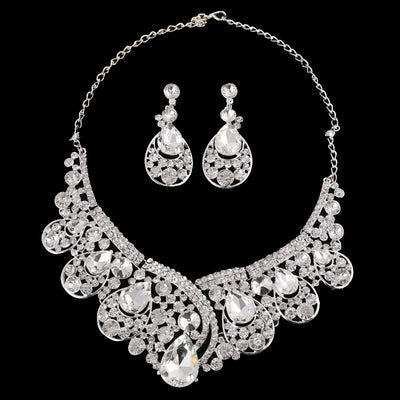 Silver-tone necklace and matching drop earrings set with clear rhinestones and teardrop crystals, ideal for weddings.