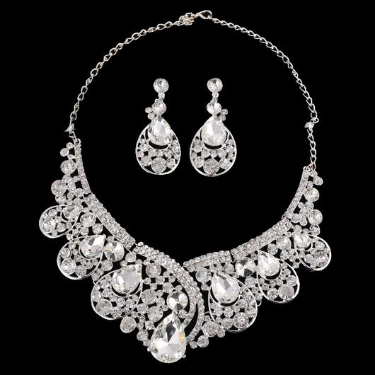 Silver-tone necklace and matching drop earrings set with clear rhinestones and teardrop crystals, ideal for weddings.