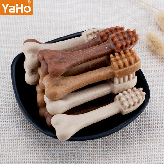 YaHo bone-shaped dog snacks in various brown and tan shades, some with dental nubs, in a black bowl.