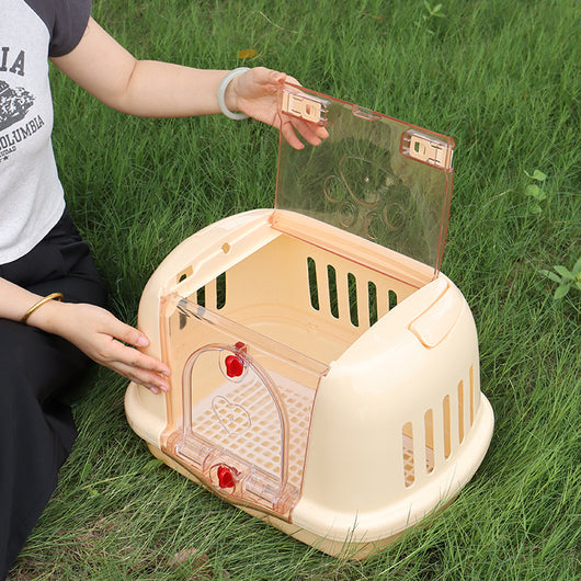 Brown pet carrier with a clear front door, top handle, ventilation slots, and a white urinating pad. - Image 4