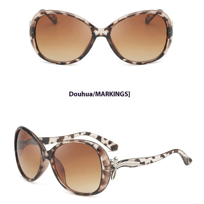 Brown oversized butterfly sunglasses with gradient lenses and a silver-tone floral accent on the temple. - Image 7