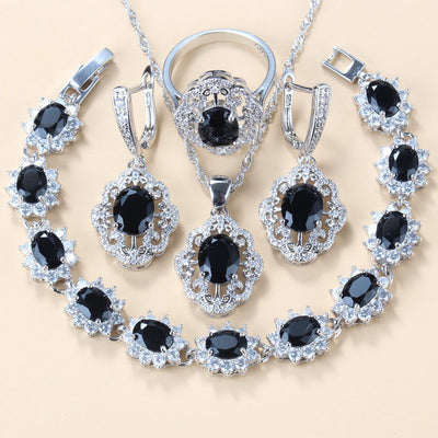 Four-piece jewelry set with silver-tone settings, featuring oval purple cubic zirconia stones surrounded by clear accents. - Image 19