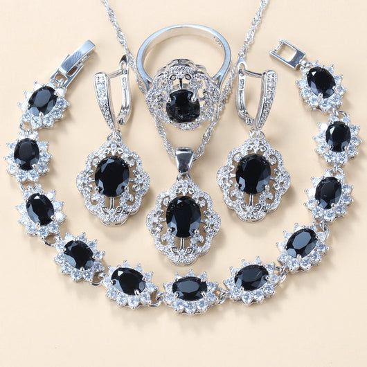 Four-piece jewelry set with silver-tone settings, featuring oval purple cubic zirconia stones surrounded by clear accents. - Image 19