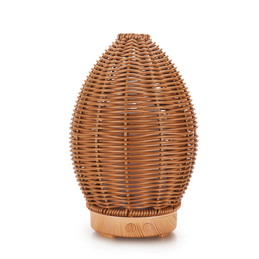 Hollow rattan aroma diffuser with an egg-shaped woven brown exterior and a light wood-grain base. - Image 3