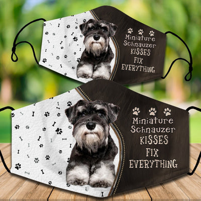 Cotton face mask with a Cavapoo dog graphic and "CAVOODLES KISSES FIX EVERYTHING" text. Features paw prints and bones.