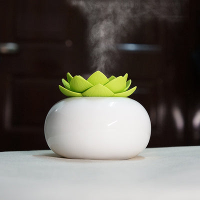 White ceramic lotus aromatherapy humidifier emitting a fine mist, perfect for home or office decor. - Image 2