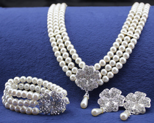 Three-piece pearl jewelry set with multi-strand necklace, bracelet, and drop earrings, all featuring sparkling rhinestone flower accents. - Image 2