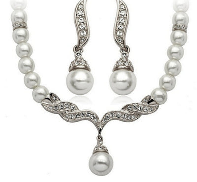 Elegant pearl necklace and matching drop earrings set with sparkling crystal accents, ideal for bridal wear. - Image 5