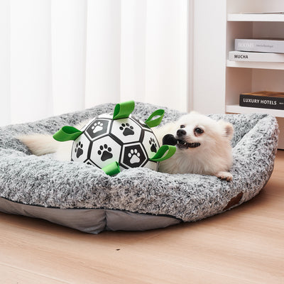 Interactive dog football toy with black and white panels, paw prints, green nylon tabs, and a green carabiner clip. Includes a black inflation pump. - Image 22
