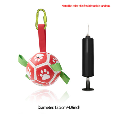 Interactive dog football toy with black and white panels, paw prints, green nylon tabs, and a green carabiner clip. Includes a black inflation pump. - Image 62