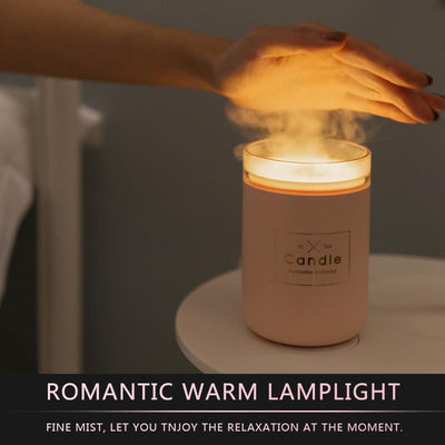 Light pink mini USB humidifier diffuser, shaped like a candle, with a clear top and visible mist output. - Image 3