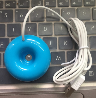 Bright blue donut-shaped mini portable USB air humidifier purifier with a white central filter and silver button. - Image 4