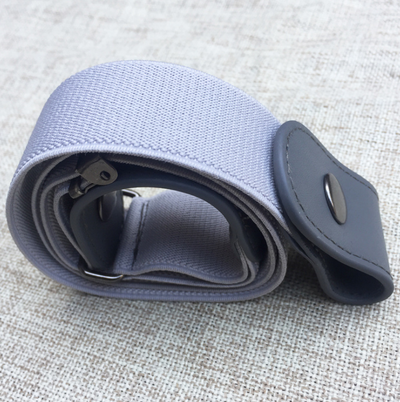 Black buckle-free elastic belt with snap closures worn on blue jeans, featuring a bonus gold-colored metal buckle. - Image 13
