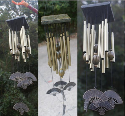 Bronze metal multi-tube wind chime with small bells, decorative coins, and red beads, hanging from a dark wooden disc. - Image 3