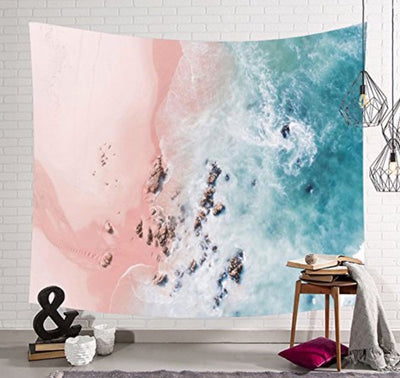 Blue ocean tapestry with an aerial view of a pink sand beach, turquoise waves, and scattered rocks.