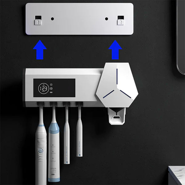 White wall-mounted toothbrush sterilizer with UVC ultraviolet light, holding four electric toothbrushes. Features a digital display and blue sterilization light