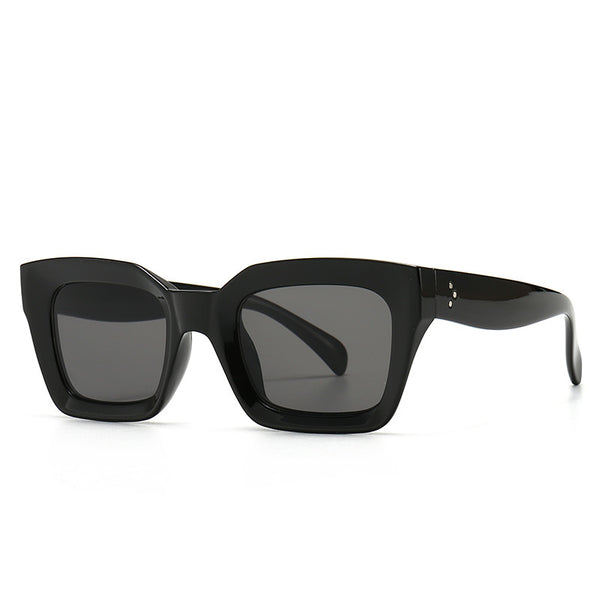 Clear square-framed glasses with a vintage style, featuring a plastic and metal frame and resin lenses.