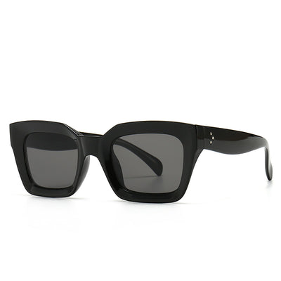 Clear square-framed glasses with a vintage style, featuring a plastic and metal frame and resin lenses.