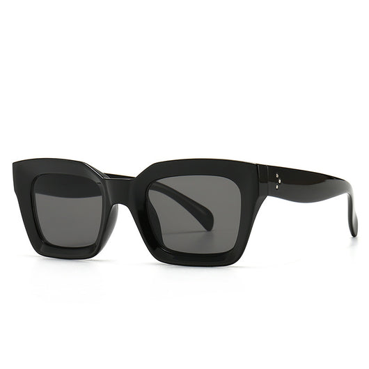 Clear square-framed glasses with a vintage style, featuring a plastic and metal frame and resin lenses.