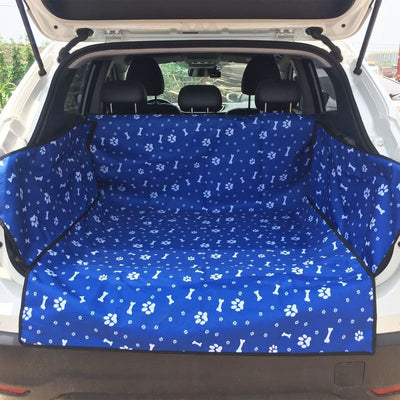 Blue waterproof pet car mat with white paw print and bone patterns installed in the trunk of a white SUV. - Image 4