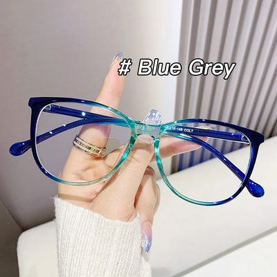 Black full-frame round anti-blue light glasses held by a hand with a gold ring and light blue gradient nails. - Image 11