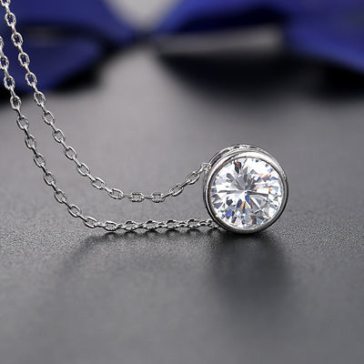 Silver-tone necklace and stud earrings set with round, bezel-set clear gemstones, ideal for bridal or formal wear. - Image 3