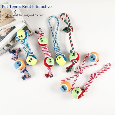 Red, pink, and white braided cotton rope dog toy with a green and red tennis ball featuring black paw prints. - Image 18