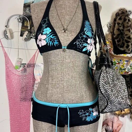 Black halter bikini suit with boy short bottoms, featuring pink and blue floral and flamingo patterns.