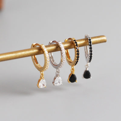 Silver-colored hoop earrings with black pave stones and dangling black teardrop-shaped stones. - Image 4