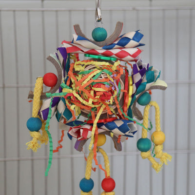 Colorful bird toy with paper tubes, shredded paper, and wooden beads, hanging inside a white wire bird cage. - Image 9
