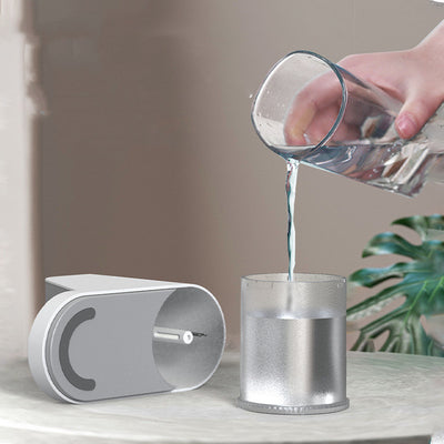 White and gray trapezoidal humidifier with a rose gold top mist outlet and control knob on a wooden desk. - Image 9
