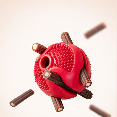Red rubber pet chew toy ball with textured nubs and four openings for dispensing treats. - Image 9