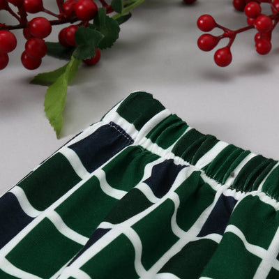Matching family Christmas pajamas with white and black raglan tops featuring a green Christmas tree graphic and plaid pants. - Image 5