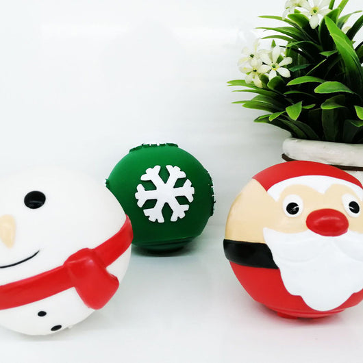 White snowman pet toy with black eyes, orange nose, smiling mouth, and red scarf, next to a potted plant. - Image 4