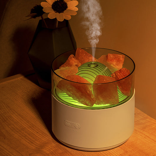 White cool-mist humidifier and aroma diffuser with glowing blue LED lights and orange crystal salt rocks, emitting mist. - Image 8