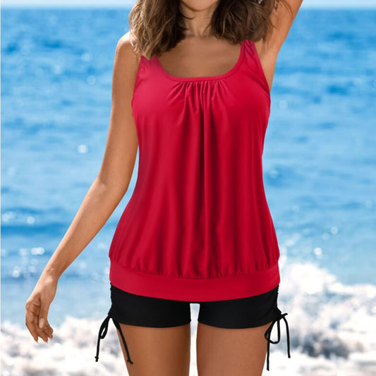 Women's red loose-fit tankini top with gathered neckline and black swim shorts with adjustable side ties.